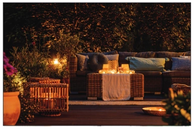 outdoor area of home with outdoor furniture and lights.